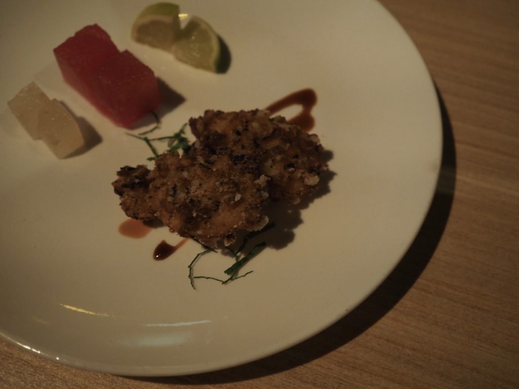 A piece of fish, served with nacho pear and watermelon cubes