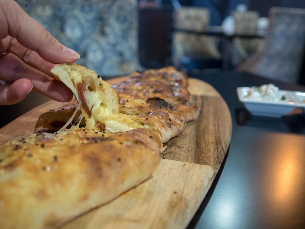 The cheese oozes out of the sujuk pide